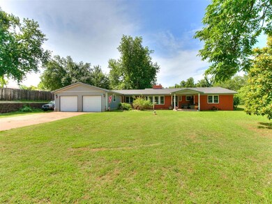 Ranch-style home with a garage and a front lawn
