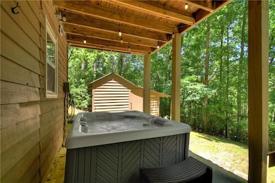 View of patio with a hot tub