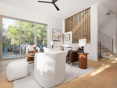 Living area with wood finished floors, a ceiling fan, stairs, and recessed lighting