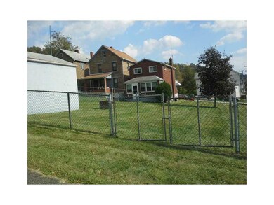 Exterior Back. large double lot is fenced in with 