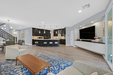Living room featuring stairway, light wood finishe