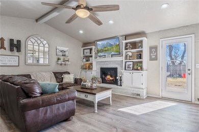 Adorable living area with fireplace and built-in b