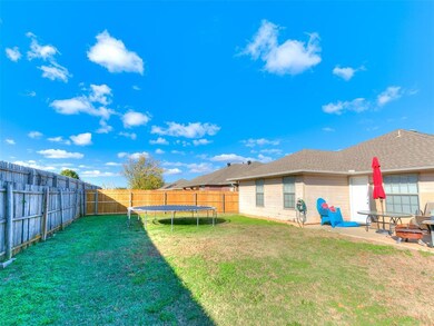 View of yard featuring a patio area and a trampoli