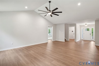 Unfurnished living room featuring light wood-type flooring, ceiling fan, high vaulted ceiling, stairs, and recessed lighting