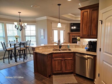 Kitchen with a notable chandelier, hanging light f