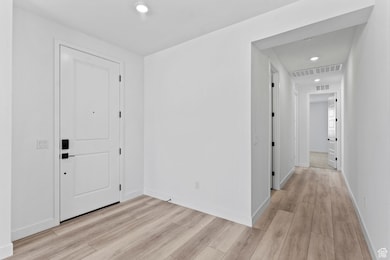 Entrance foyer featuring recessed lighting and light wood finished floors