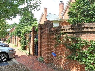 Brick walkway and enclosed patios along on the bac