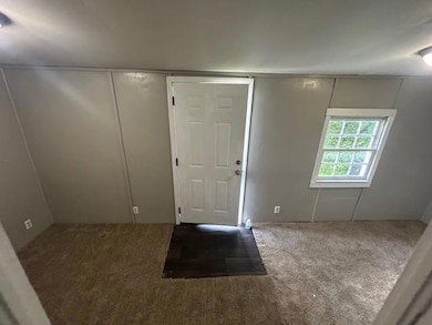 Entrance foyer with carpet flooring