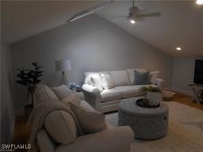 Living room with vaulted ceiling and ceiling fan