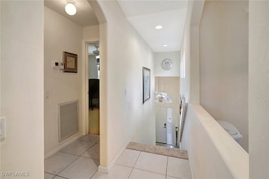Corridor with light tile patterned floors