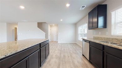Kitchen with stainless steel dishwasher, visible v
