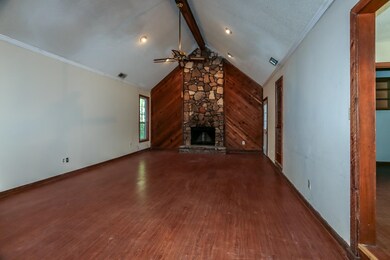 Unfurnished living room featuring ornamental moldi