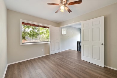 * Back bedroom with wood finished floors and ceiling fan
