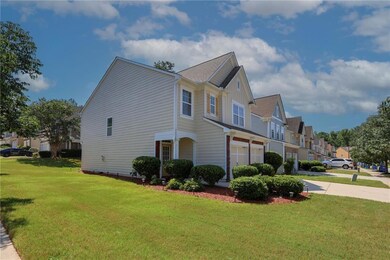 View of home's exterior featuring board and batten siding, a residential view, concrete driveway, a yard, and a garage
