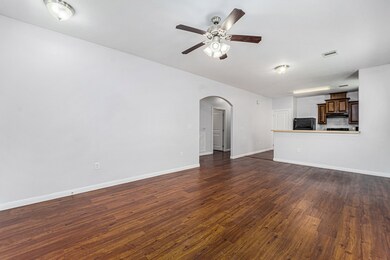 This spacious living area features hardwood lookin