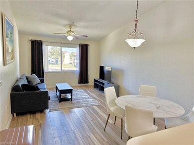 Living area with a ceiling fan, baseboards, and light wood-style floors