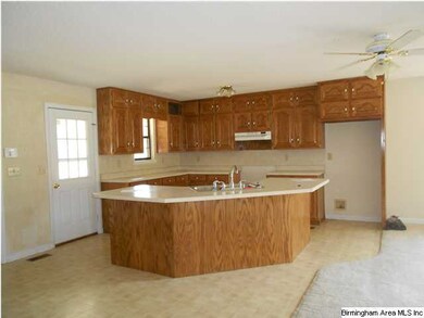 Kitchen with bar opening to living/dining area.