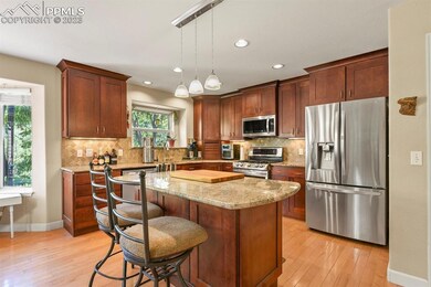 A well appointed island and granite counter tops.