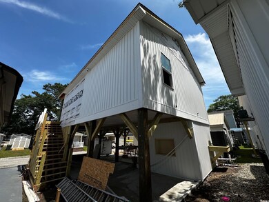 View of property exterior with stairs, a shed, and