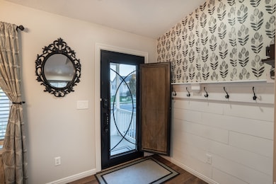 Adorable entrance with built in screen door and stylish coat rack