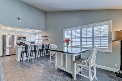 Kitchen and dining area with beautiful high ceilings and opening to the covered patio for 24/7 entertaining!