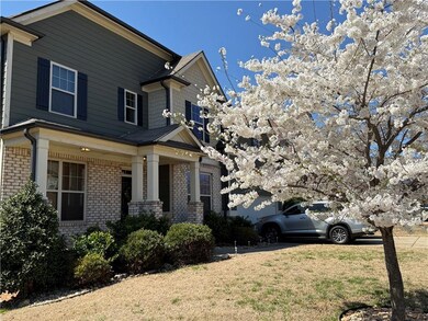 View of front of property with brick siding, a gar