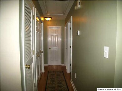 Long hallway leading to bedrooms.