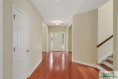 Foyer entrance with hardwood floors throughout the