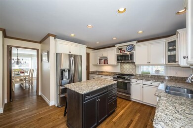 Down the hall from the foyer is the kitchen which is filled with sunlight and personal touches.