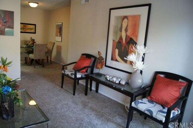 Open and airy living room leads to kitchen and din