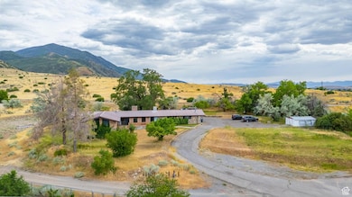 View of mountain backdrop with rural landscape