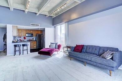 View from the second balcony to the living room and kitchen.