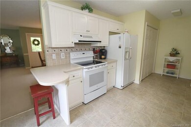 Kitchen includes a small breakfast bar.  Closet to