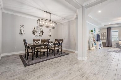 Formal dining w/crown molding & designer lighting