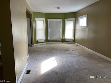 Carpeted spare room with a textured ceiling