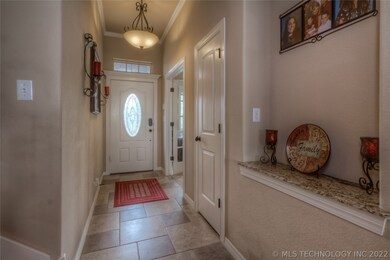 Foyer w/ coat closet and crown molding, adjacent t