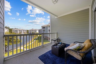 Balcony featuring a water view and a residential view