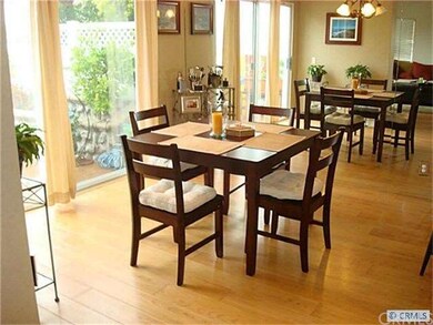 Dining room with large mirror on one wall, opens t