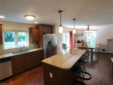 Spacious kitchen boasts newer maple cabinets, gran