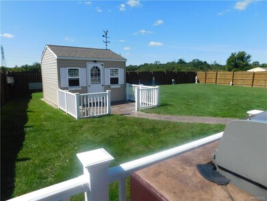 Newer shed with concrete walkway.