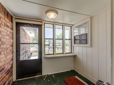 Entryway featuring brick wall