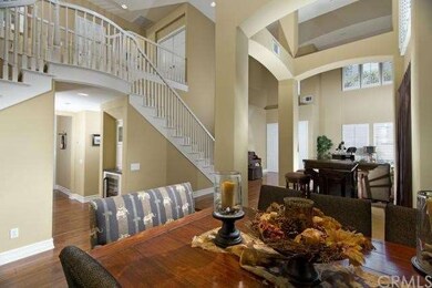 Formal dining room and view of elegant staircase