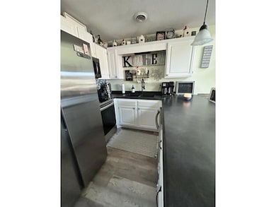 Kitchen featuring sink, a textured ceiling, decora