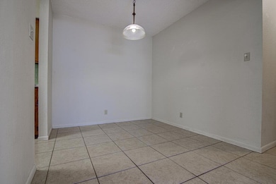 Unfurnished room featuring light tile patterned f