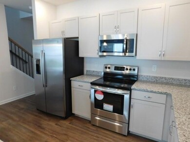 Kitchen featuring appliances with stainless steel finishes and dark wood finished floors