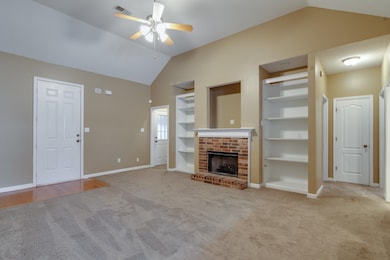 Unfurnished living room with lofted ceiling, built
