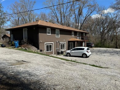 View of front facade featuring gravel driveway and roof with shingles