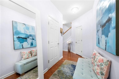 Hall featuring baseboards, wood finished floors, a