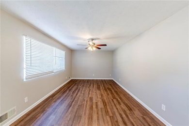 Spare room with ceiling fan and dark hardwood / wo