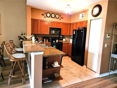 Kitchen featuring stone countertops, light hardwoo